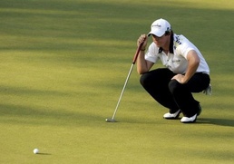 Rory McIlroy of Northern Ireland lines up a putt McIlroy in charge at Masters as Woods fades