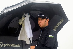Dustin Johnson shelters from the rain under an umbrella on the 6th tee 'Nearly man' Johnson ready to seize Open chance