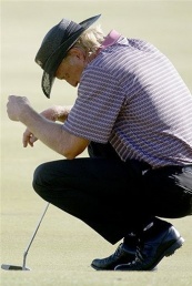 Greg Norman reacts on the 18th hole after missing the cut to continue on day two of the Johnnie Walk Norman ready to shrug off Masters heartache