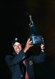 Tiger Woods celebrates with his trophy Tiger wins first golf title since layoff
