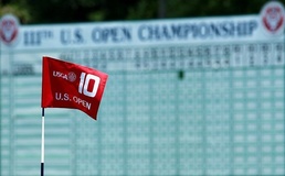The flag on the tenth hole blows in the breeze during a practice round US Open stars face testy 10th-tee start