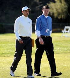 Tiger Woods (L) walks with his agent Mark Steinberg Woods named PGA Tour player of the year